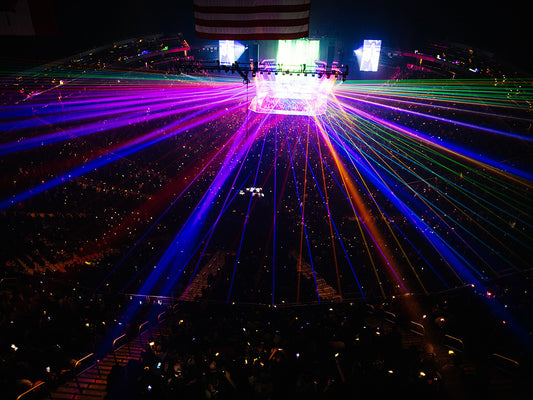 Panic at the Disco band plays on stage as lasers blast overhead